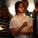 Bret Kelly, of Ypsilanti, participates in a candle light vigil as part of a prayer vigil in support of Camp Take Notice at St. Mary Student Parish on Thursday night.  Melanie Maxwell I AnnArbor.com